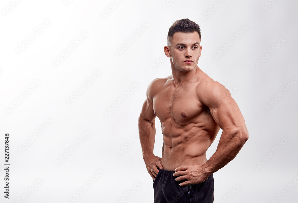 Fototapeta premium Bodybuilder man with perfect abs, shoulders,biceps, triceps and chest, personal fitness trainer. Unrecognizable Strong bodybuilder.