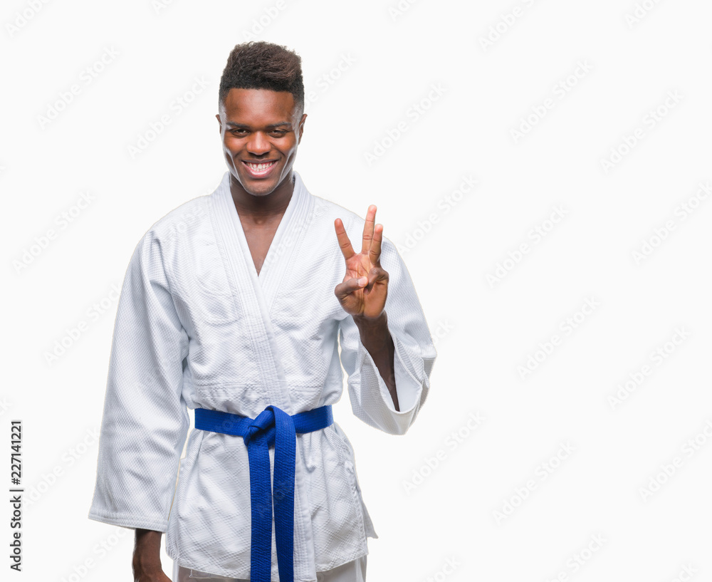 Young african american man over isolated background wearing kimono showing and pointing up with fingers number three while smiling confident and happy. Young african american man over isolated background wearing kimono showing and pointing up with fingers number three while smiling confident and happy.