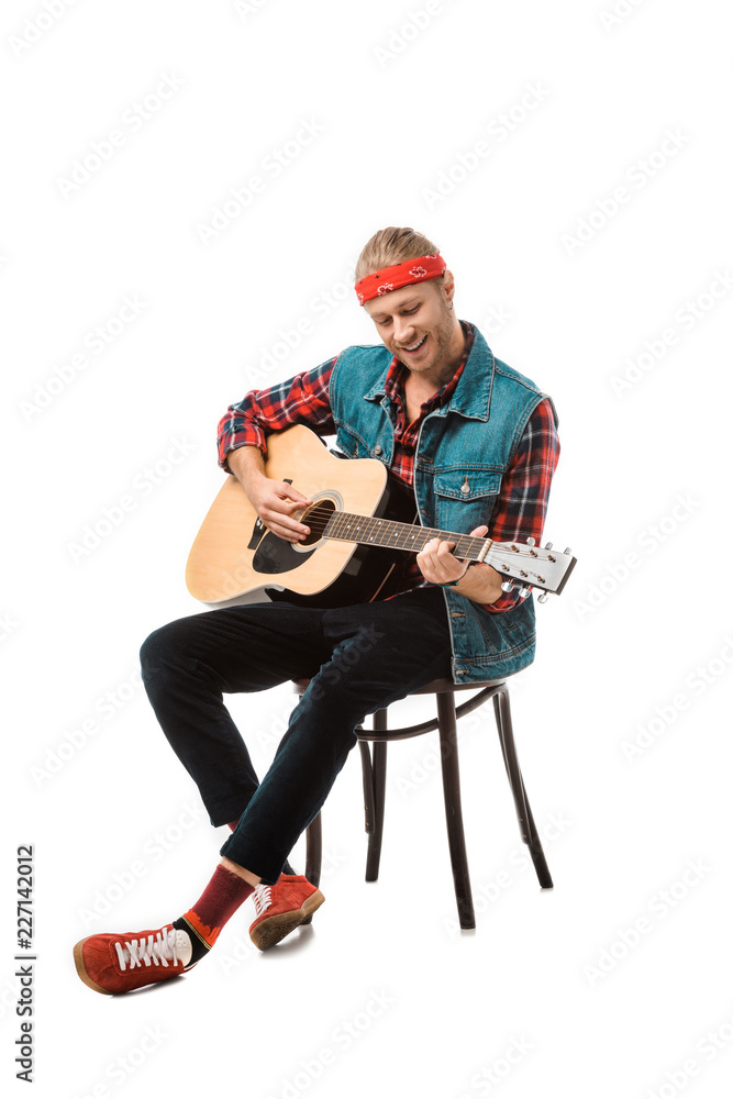 happy hipster man in denim vest playing on acoustic guitar isolated on white happy hipster man in denim vest playing on acoustic guitar isolated on white