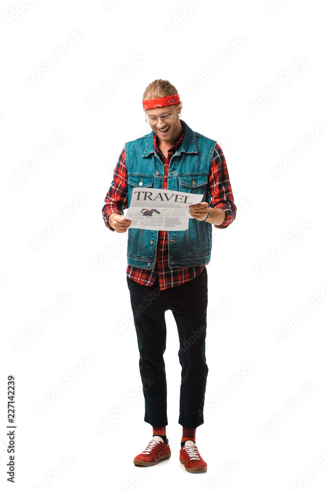 cheerful hipster man in denim vest reading travel newspaper isolated on white cheerful hipster man in denim vest reading travel newspaper isolated on white