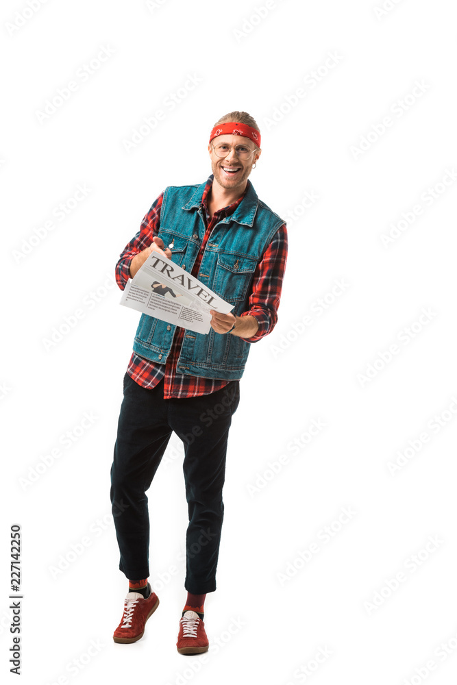 laughing hipster man in denim vest reading travel newspaper isolated on white laughing hipster man in denim vest reading travel newspaper isolated on white