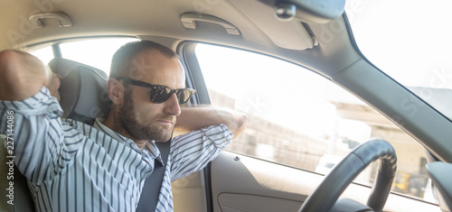 Concentrated and pensive driver in his car © tostphoto