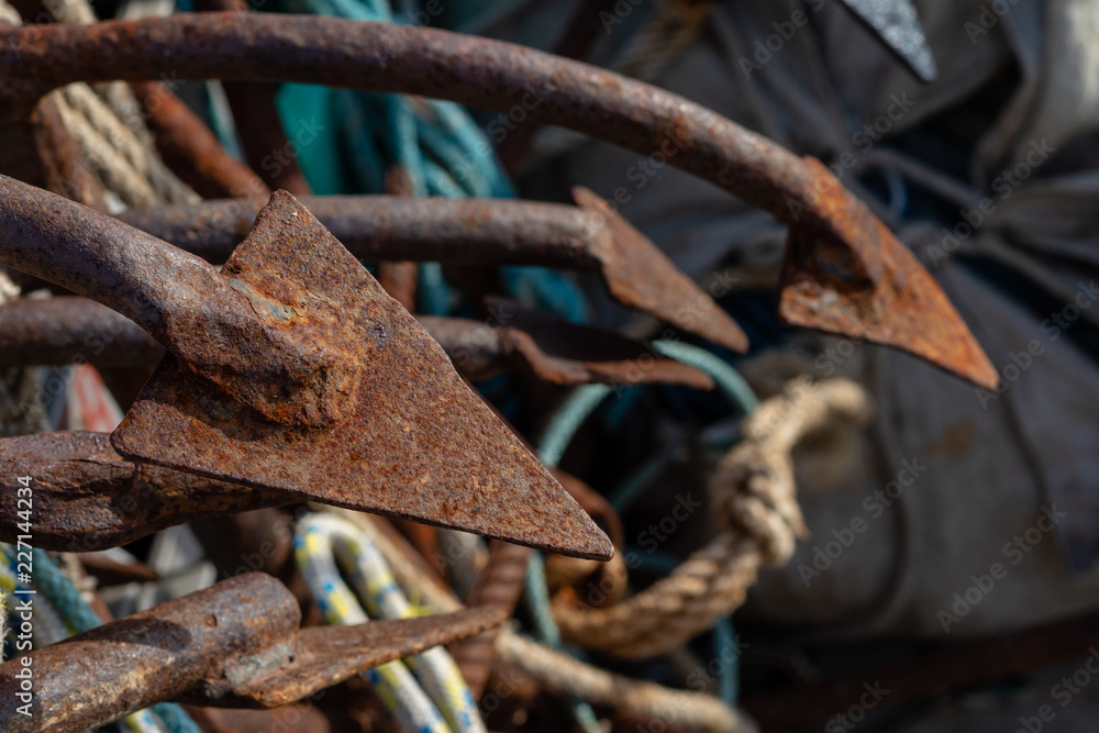 Anchor used for anchoring fishing nets. Fishing accessories in the port of central europe. Anchor used for anchoring fishing nets. Fishing accessories in the port of central europe.