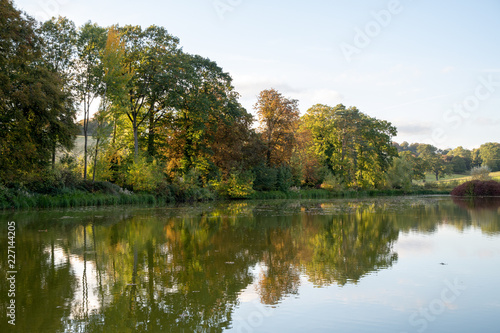 Lake in English countryside with trees and reflection. Takenon an autumn afternoon
