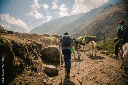 Hiking Man Following Tour Guides In Peru