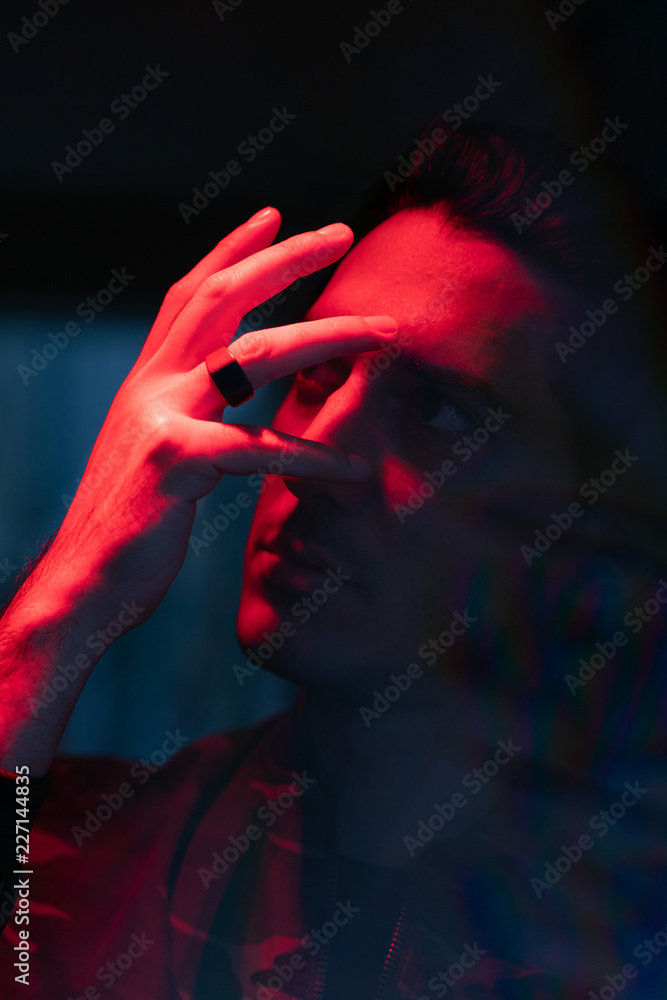 Portrait of man with hand and reflection of himself Portrait of man with hand and reflection of himself