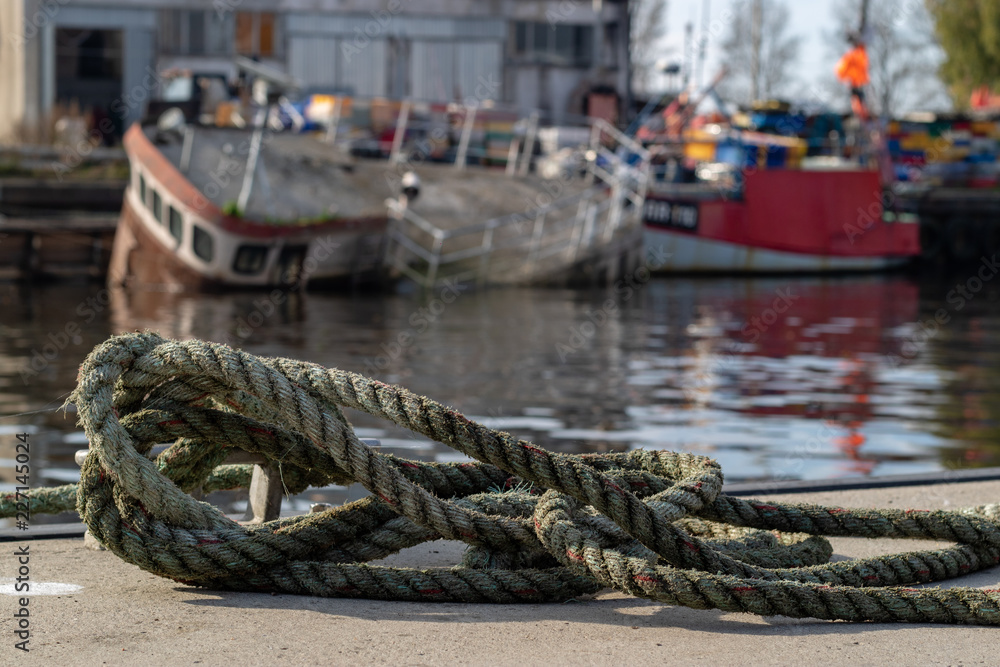 Mooring rope of a fishing boat in a fishing port. Rigging of vessels in central europe.