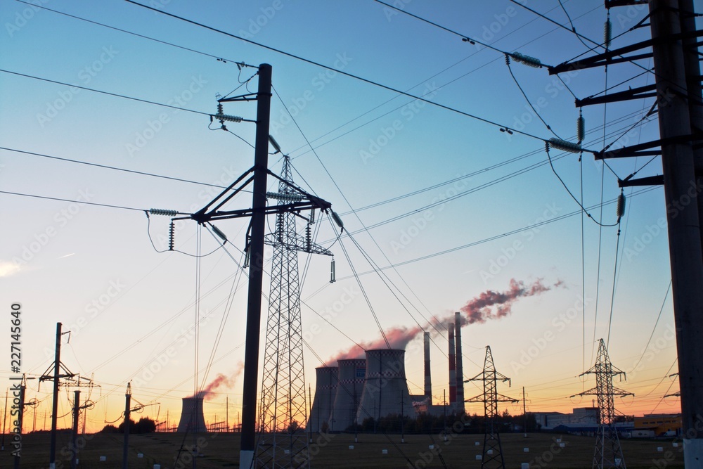 electricity pylons and thermal power plant at sunset