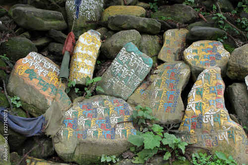 Translation: The mantra Om Mani Padme Hum painted on mani stones or rocks photo