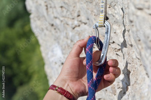Clip carabiner in the hand on rope