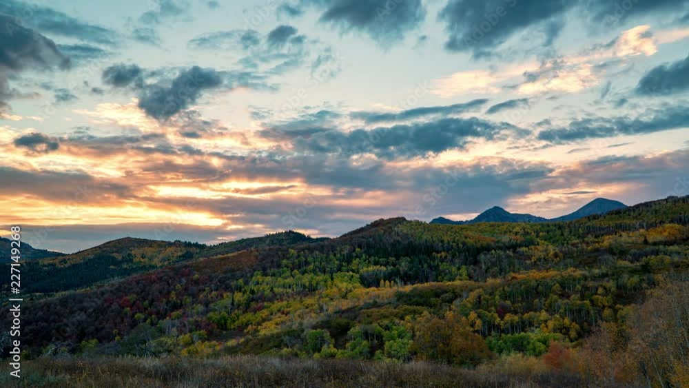 Time lapse of sun setting over mountain layers viewing colorful landscape during Fall. Time lapse of sun setting over mountain layers viewing colorful landscape during Fall.