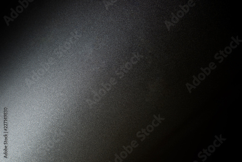 Texture of dark grey and light on surface of metal plate. Closeup for background.