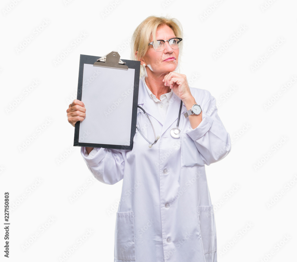 Middle age blonde doctor woman holding clipboard over isolated background serious face thinking about question, very confused idea Middle age blonde doctor woman holding clipboard over isolated background serious face thinking about question, very confused idea