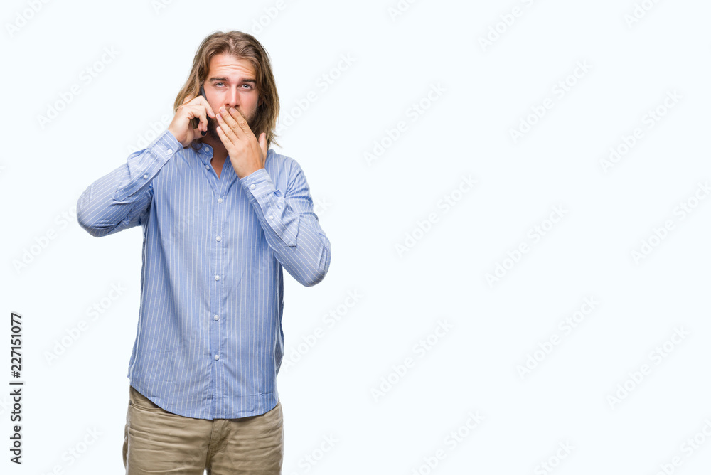 Young handsome man with long hair over isolated background talking on the phone cover mouth with hand shocked with shame for mistake, expression of fear, scared in silence, secret concept Young handsome man with long hair over isolated background talking on the phone cover mouth with hand shocked with shame for mistake, expression of fear, scared in silence, secret concept
