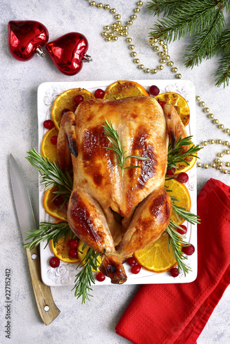 Roasted chicken with oranges ,rosemary and cranberries.Top view with copy space.