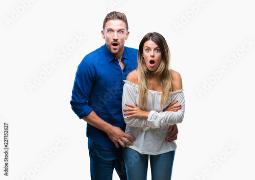 Young couple in love over isolated background afraid and shocked with surprise expression, fear and excited face.