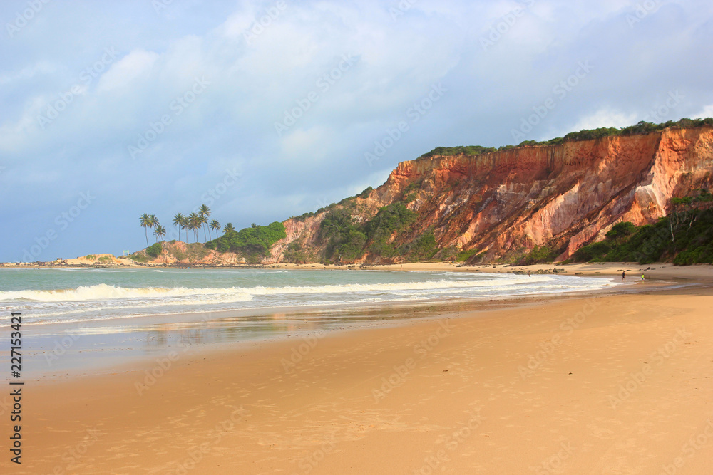 Tabatinga Beach in Conde, Paraíba: cliffs, palm trees, waves, rocks