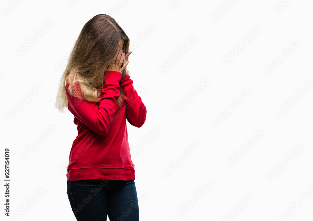 Young beautiful blonde woman wearing red sweater over isolated background with sad expression covering face with hands while crying. Depression concept. Young beautiful blonde woman wearing red sweater over isolated background with sad expression covering face with hands while crying. Depression concept.