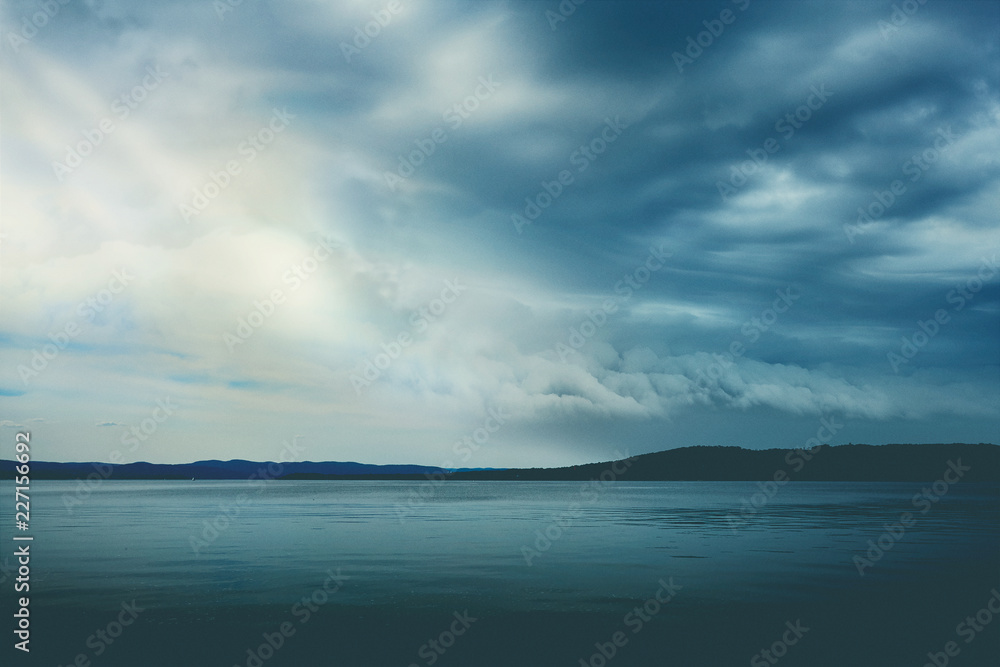 Blue sky over water and mountains Blue sky over water and mountains