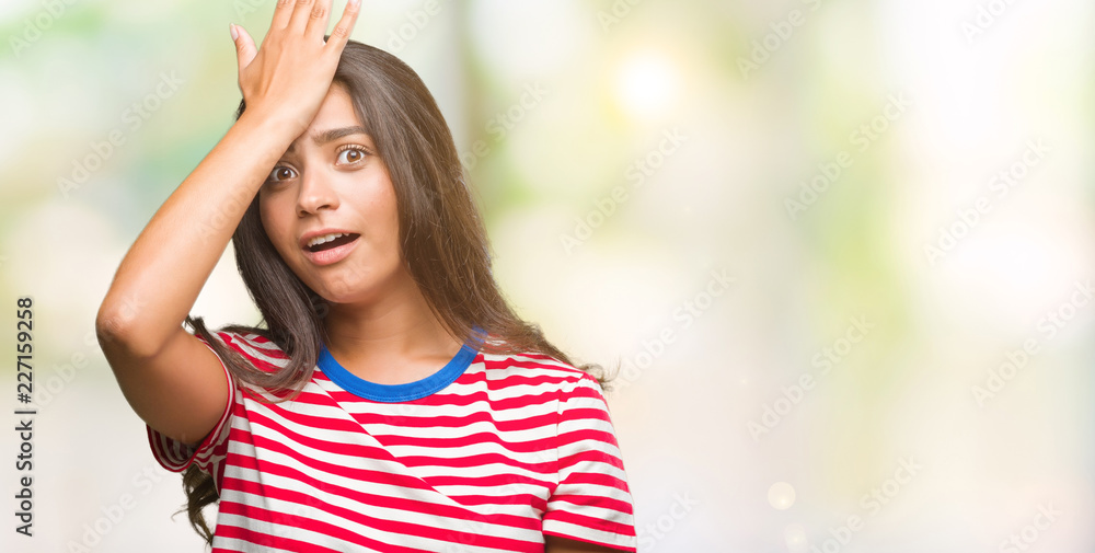 Young beautiful arab woman over isolated background surprised with hand on head for mistake, remember error. Forgot, bad memory concept.