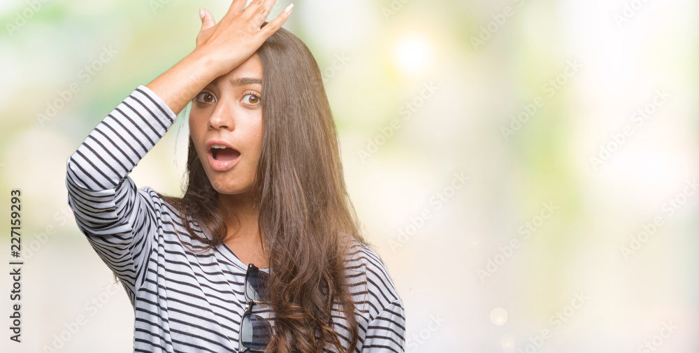 Young beautiful arab woman wearing sunglasses over isolated background surprised with hand on head for mistake, remember error. Forgot, bad memory concept.