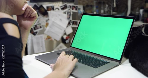 Woman using green screen laptop