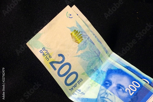 200 Israeli shekels bills on black