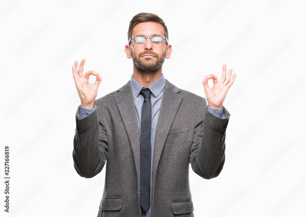 Young handsome business man over isolated background relax and smiling with eyes closed doing meditation gesture with fingers. Yoga concept. Young handsome business man over isolated background relax and smiling with eyes closed doing meditation gesture with fingers. Yoga concept.