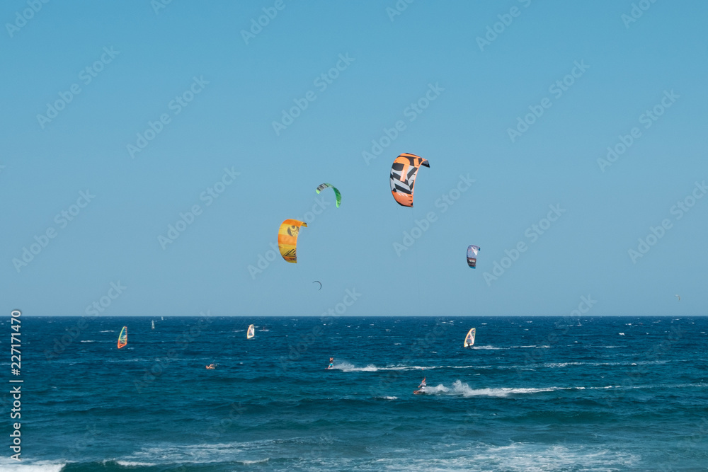 kitesurfer and windsurfer on ocean at El Medano Beach kitesurfer and windsurfer on ocean at El Medano Beach