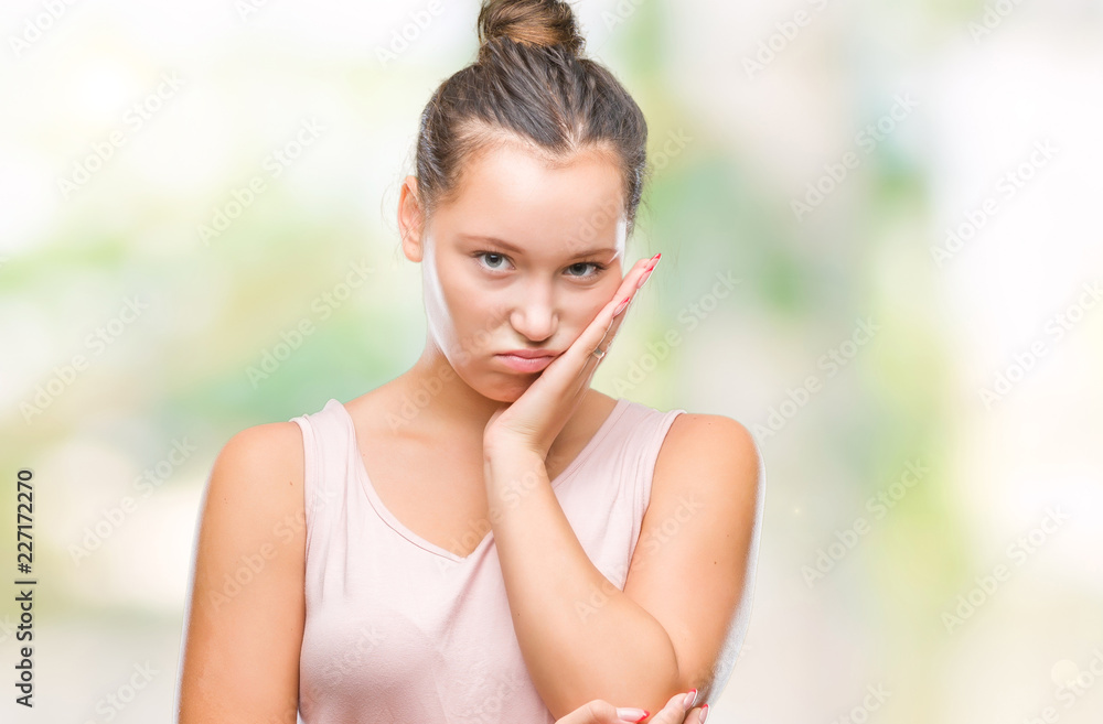Young caucasian beautiful woman over isolated background thinking looking tired and bored with depression problems with crossed arms.