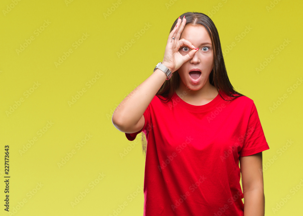 Young beautiful caucasian woman over isolated background doing ok gesture shocked with surprised face, eye looking through fingers. Unbelieving expression. Young beautiful caucasian woman over isolated background doing ok gesture shocked with surprised face, eye looking through fingers. Unbelieving expression.