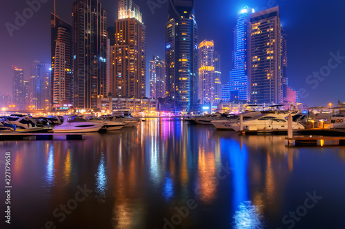 Beautiful view to Dubai Marina, UAE. Luxury yachts at pier. Long exposure tim...