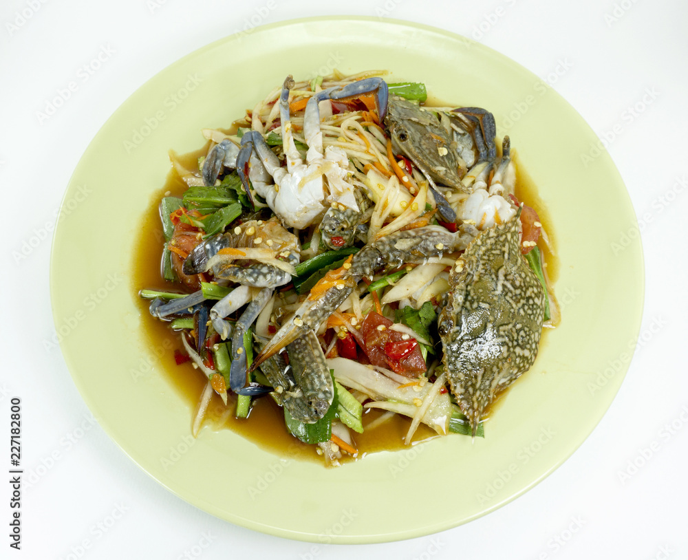 Papaya Salad with Blue Crab.Thai style spicy food, Som Tum in a green plate on wood floor table, Thai foods. Top view Copy Space. Papaya Salad with Blue Crab.Thai style spicy food, Som Tum in a green plate on wood floor table, Thai foods. Top view Copy Space.
