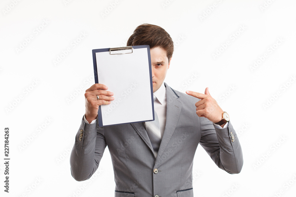 Young businessman showing blank clipboard, isolated on white background. Success in business, job and education concept shot Young businessman showing blank clipboard, isolated on white background. Success in business, job and education concept shot