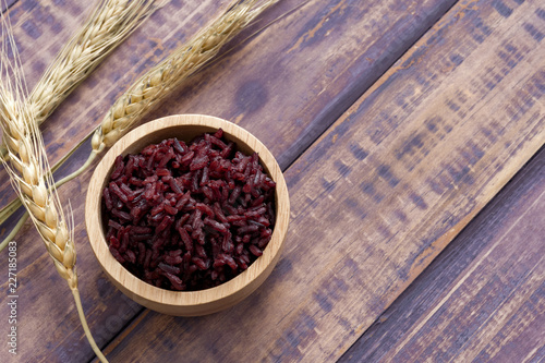 Wooden bowl with brown rice ready to eat. Deep Purple rice, Homnil rice. photo