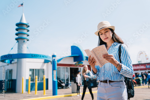 a female traveler reading the guidebook