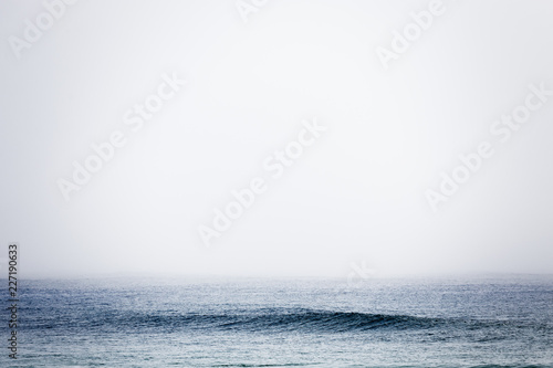 Minimalist foggy blue sea and sky photo