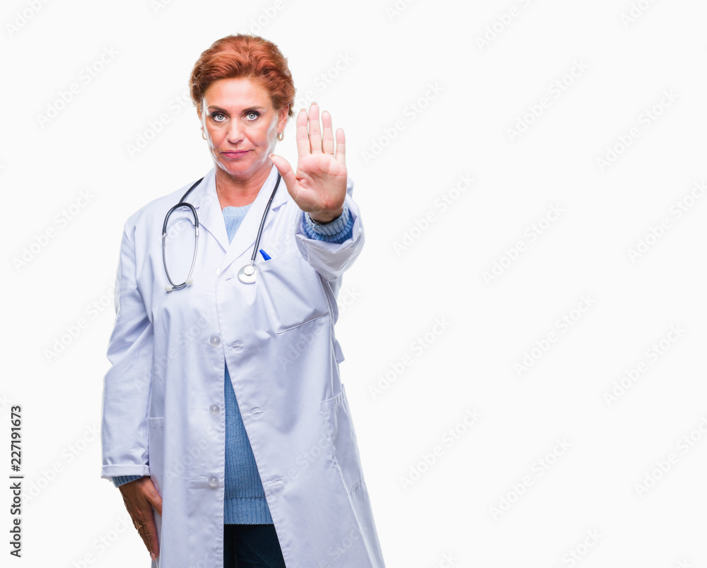 Senior caucasian doctor woman wearing medical uniform over isolated background doing stop sing with palm of the hand. Warning expression with negative and serious gesture on the face. Senior caucasian doctor woman wearing medical uniform over isolated background doing stop sing with palm of the hand. Warning expression with negative and serious gesture on the face.