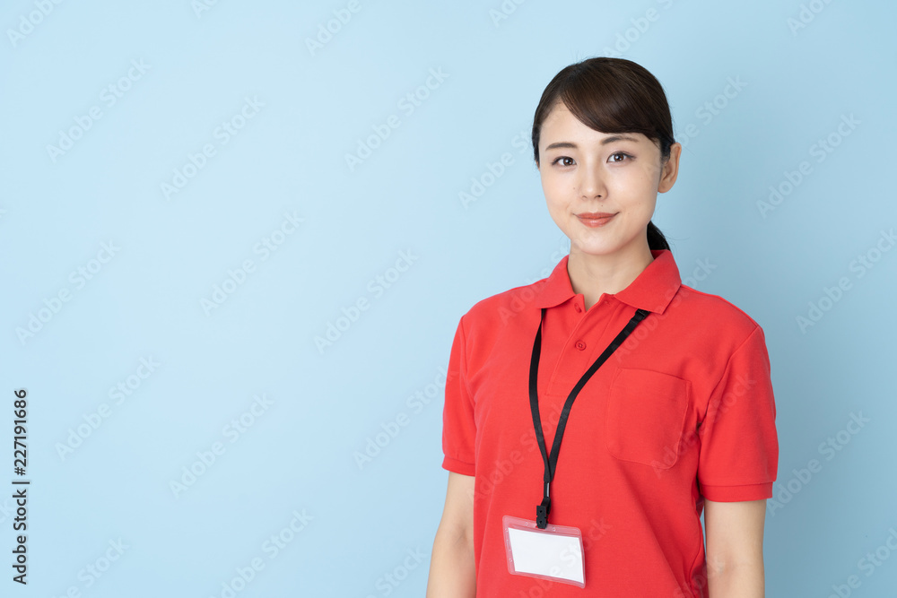 portrait of young asian woman wearing red polo shirts on blue background portrait of young asian woman wearing red polo shirts on blue background