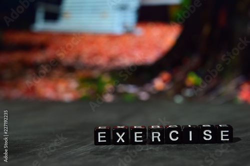 Exercise on wooden blocks. Cross processed image with bokeh background