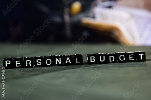 Personal budget on wooden blocks. Business and finance concept. Cross processed image with bokeh background