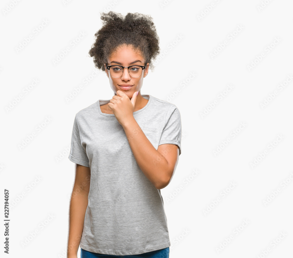Young afro american woman wearing glasses over isolated background looking confident at the camera with smile with crossed arms and hand raised on chin. Thinking positive. Young afro american woman wearing glasses over isolated background looking confident at the camera with smile with crossed arms and hand raised on chin. Thinking positive.