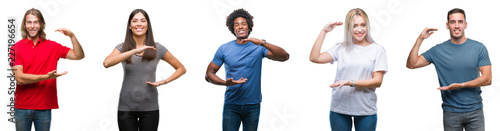 Composition of african american, hispanic and caucasian group of people over isolated white background gesturing with hands showing big and large size sign, measure symbol. Smiling 