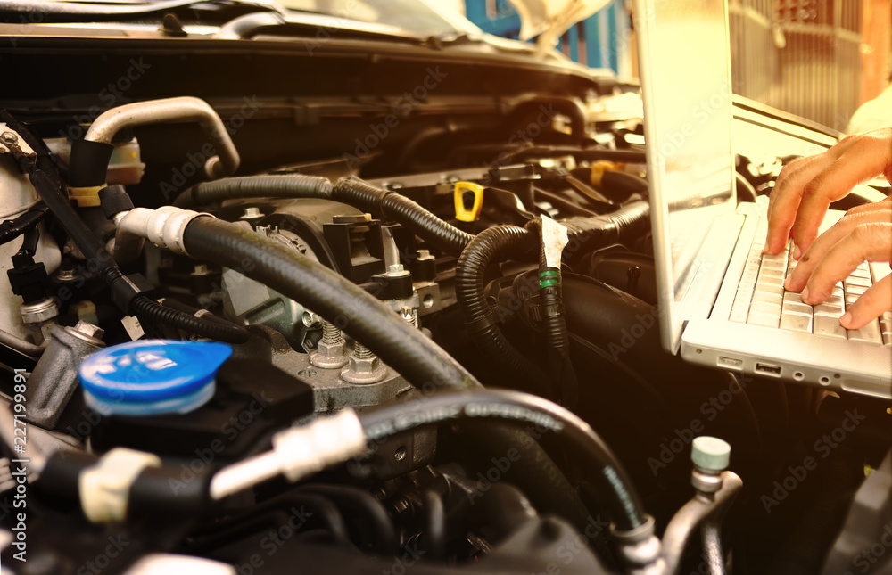 Mechanic using Laptop Diagnostic machine tools for car. Mechanic using Laptop Diagnostic machine tools for car.