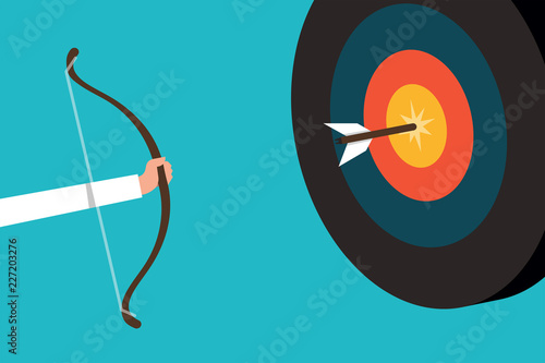 Businessman shooting arrow to bulletes target 