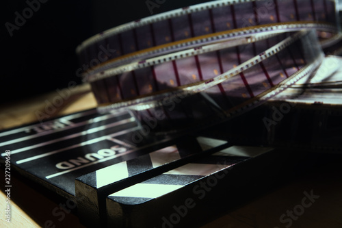 Movie clapper and film reel on a background