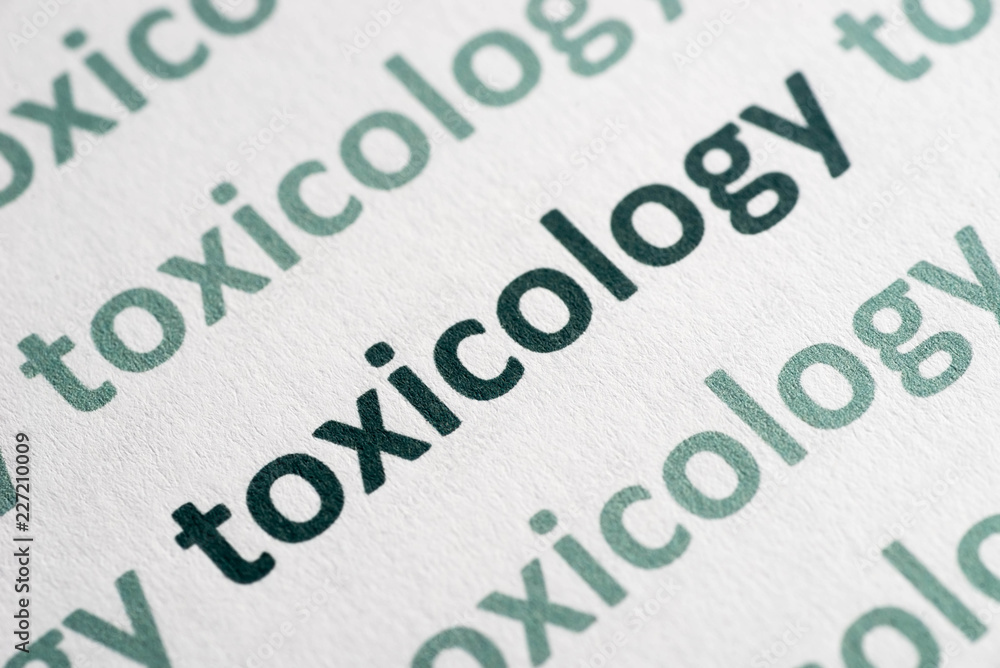 word toxicology printed on paper macro - obrazy, fototapety, plakaty 