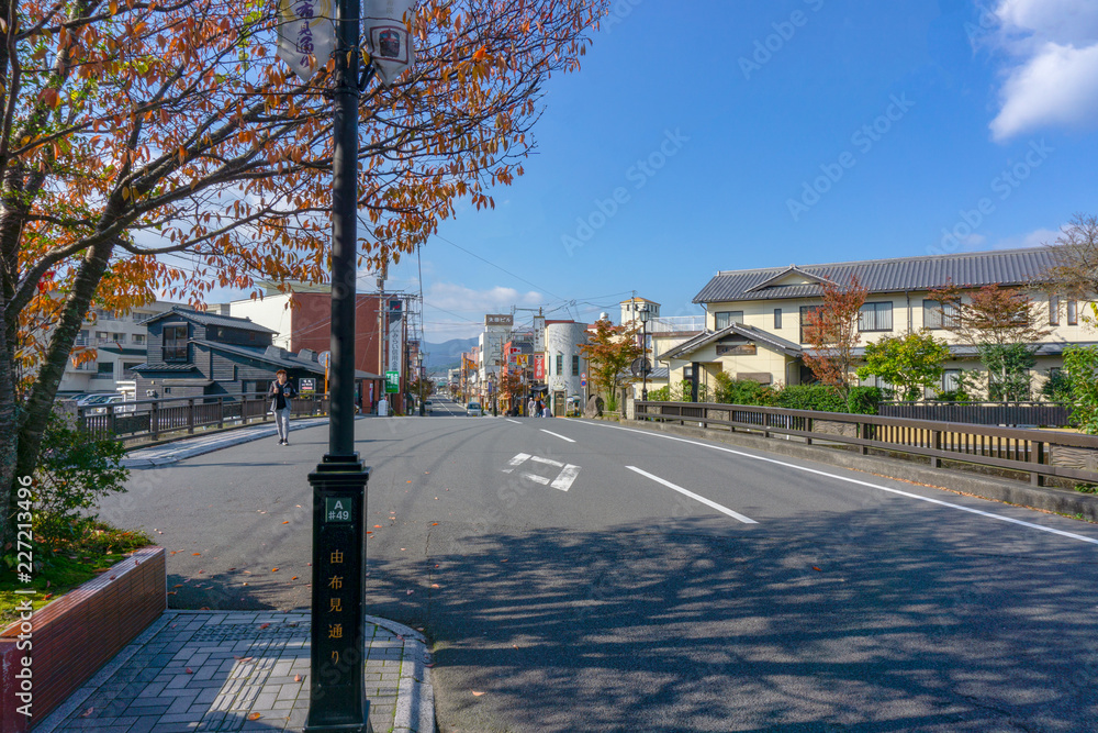 The View of Oita river flowing through Yufuin city with Mount Yufu in Background and blue sky with clouds in autumn. onsen town, Yufuin, Oita, Kyushu, Japan