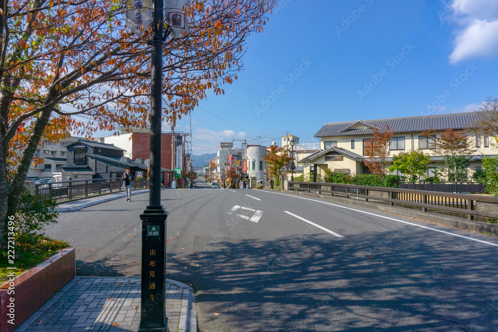The View of Oita river flowing through Yufuin city with Mount Yufu in Background and blue sky with clouds in autumn. onsen town, Yufuin, Oita, Kyushu, Japan The View of Oita river flowing through Yufuin city with Mount Yufu in Background and blue sky with clouds in autumn. onsen town, Yufuin, Oita, Kyushu, Japan