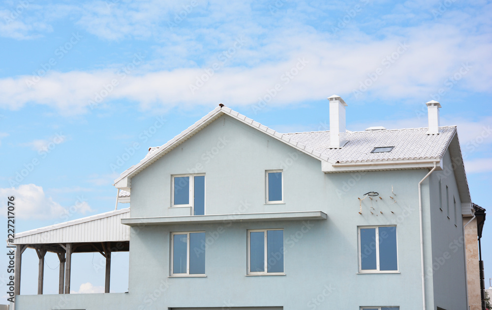 Unfinished modern white color house with white tiles roof.